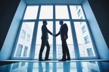 Photo of successful businessmen handshaking after striking deal