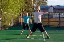 Children doing morning exercises outdoor.