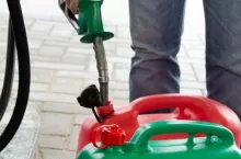 Man in jeans gas station in a plastic gasoline canister 98E
