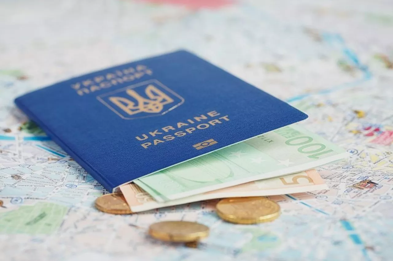 Travel and tourism concept: ukrainian passport and money on a map