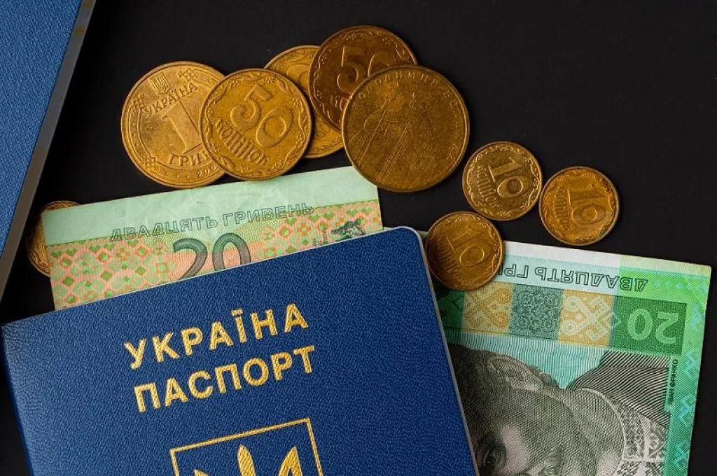 Ukrainian hryvnia banknotes in ukrainian passport close up