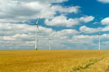 Eolian generators in a beautiful wheat field. eolian turbine farm,wind turbine, wind field with wind turbines. Wind propeller. Wheat Fiel Agriculture.