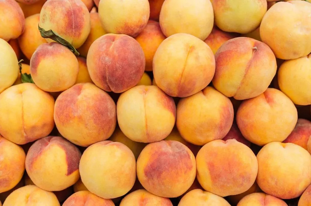 Closeup of fresh ripe peaches background