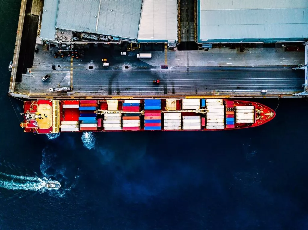 Aerial top view of container ship at sea port