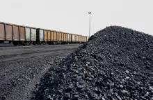Piles of processed coal next to a rail siding waiting to be put on a train for transporting to a coastal port