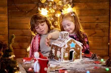 &lt;p&gt;Happy kids creating a Christmas gingerbread house in a decorated room for the holidays.&lt;/p&gt;