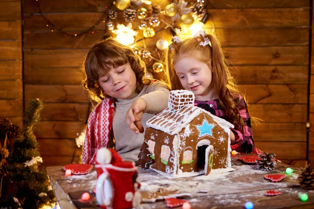 &lt;p&gt;Happy kids creating a Christmas gingerbread house in a decorated room for the holidays.&lt;/p&gt;