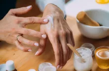 Woman Applying Homemade Hand Cream onto her Hands