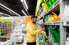 &lt;p&gt;a man in a gardening store buys a plastic garden watering can.&lt;/p&gt;