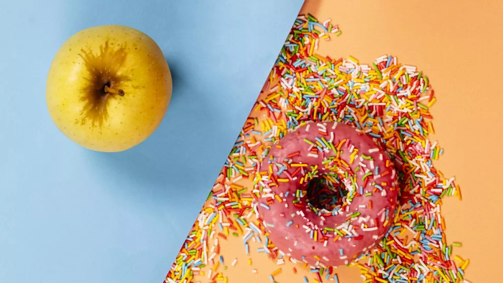 &lt;p&gt;Healthy food versus processed food concept. Strawberry donut and a fruit.&lt;/p&gt;
