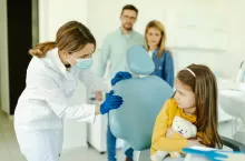 &lt;p&gt;Child looking scared at female dentist sitting in dental chair.&lt;/p&gt;
