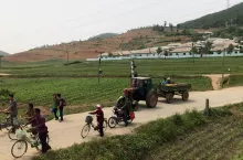 South Pyongan, North Korea - 06 June 2018: A group of local people waiting the train to pass.