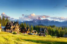 Traditional wooden house in the mountains on a green field Mountains, Poland. Europe