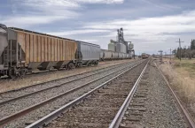 Grain elevators and train on the prairie near Bashaw, Alberta, Canada