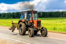 CHELYABINSK REGION, RUSSIA - JULY 10, 2017: Red agricultural tractor MTZ 82 at the countryside.