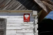 Sierpc, Poland - July 2022A red plate with a name of a village administrator ”Soltys” on a facade of a wooden village hut in the Museum of the Mazovian Countryside in Sierpc. Selected focus.
