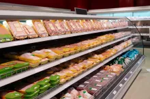Fresh chicken meat on supermarket shelf, all logos removed