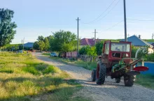 rural road tractor with green grass and blue sky