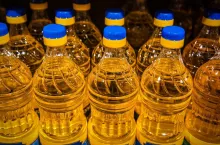 plastic bottles of oil on supermarket shelves
