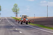 Tractor on the country road at summer
