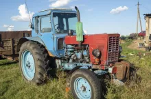 26.07.2020 Russia, Bryansk region. Old Tractor blue parking I.in iackyard In Summer Sunny Day. Special Agricultural Equipment.