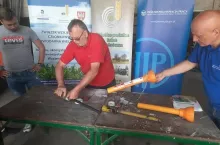 Mężczyźni wymieniają osłony WOM ciągnika rolniczego