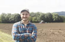 Portrait of farmer looking at camera, arms crossed smiling