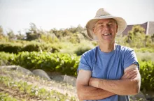 Portrait Of Mature Man Standing On Allotment