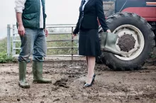 business woman at muddy farm